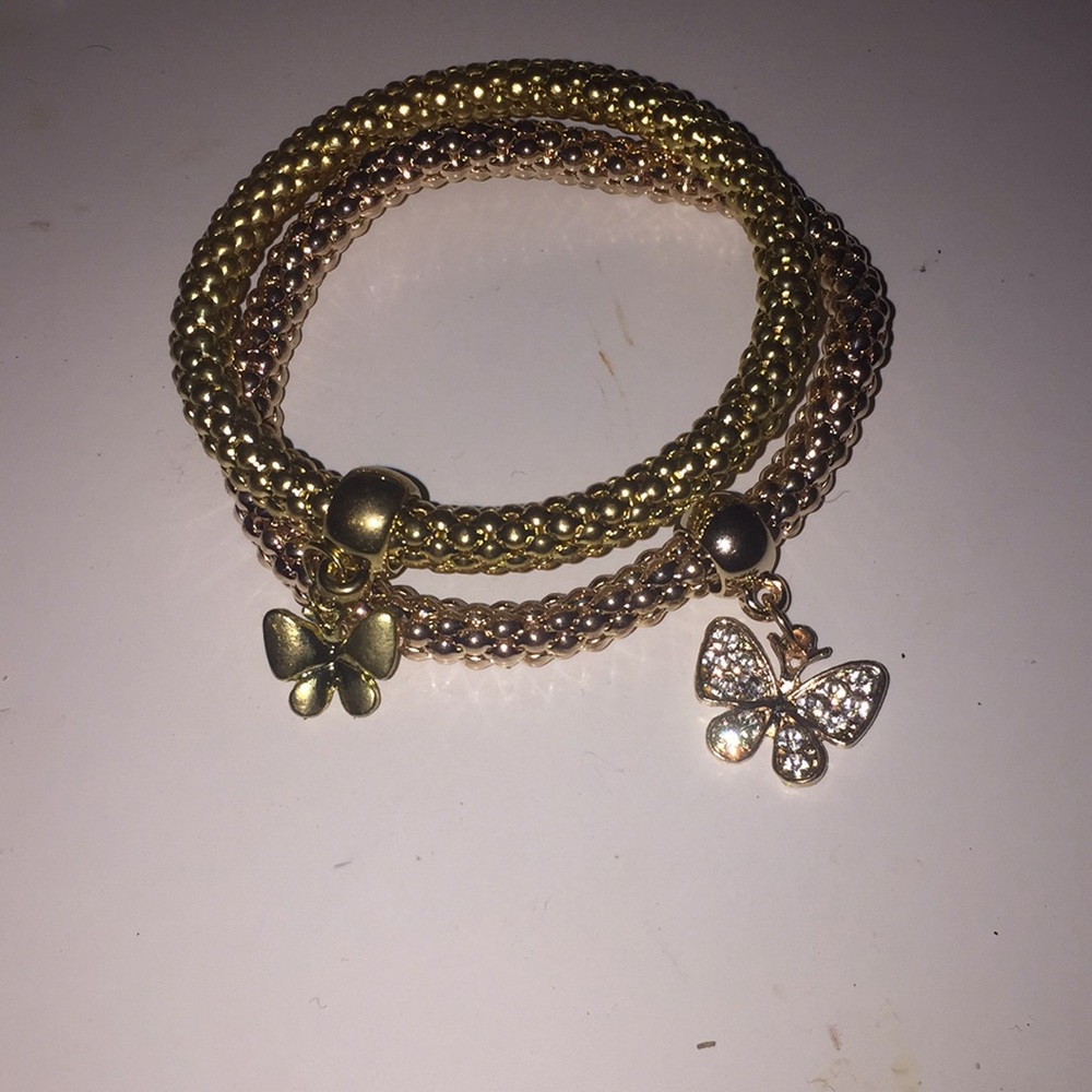 2 gold bracelets with silver butterflies